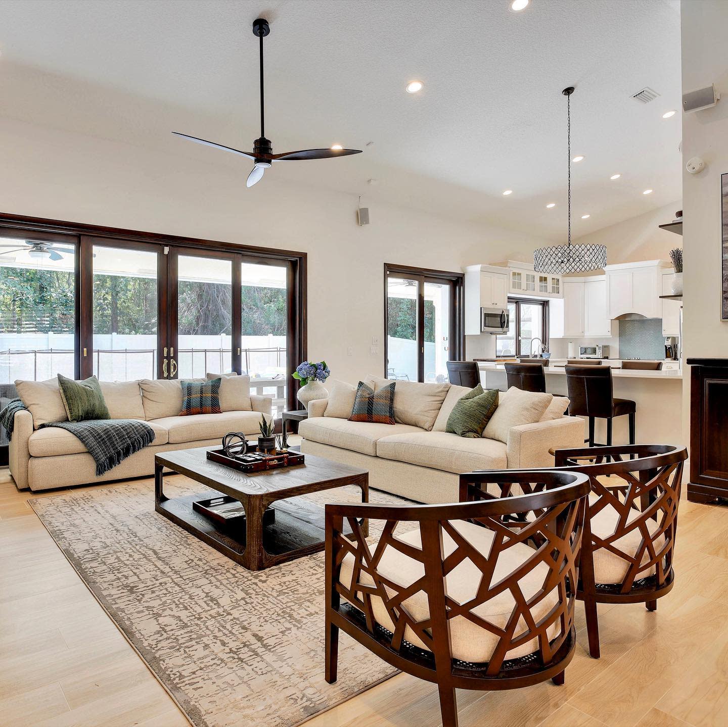 modern open kitchen living room white sofa wood accents 